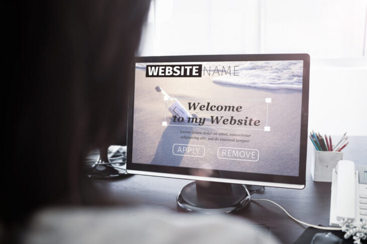 Composite image of build website interface against casual businesswoman working on laptop Casual businesswoman working on laptop at office